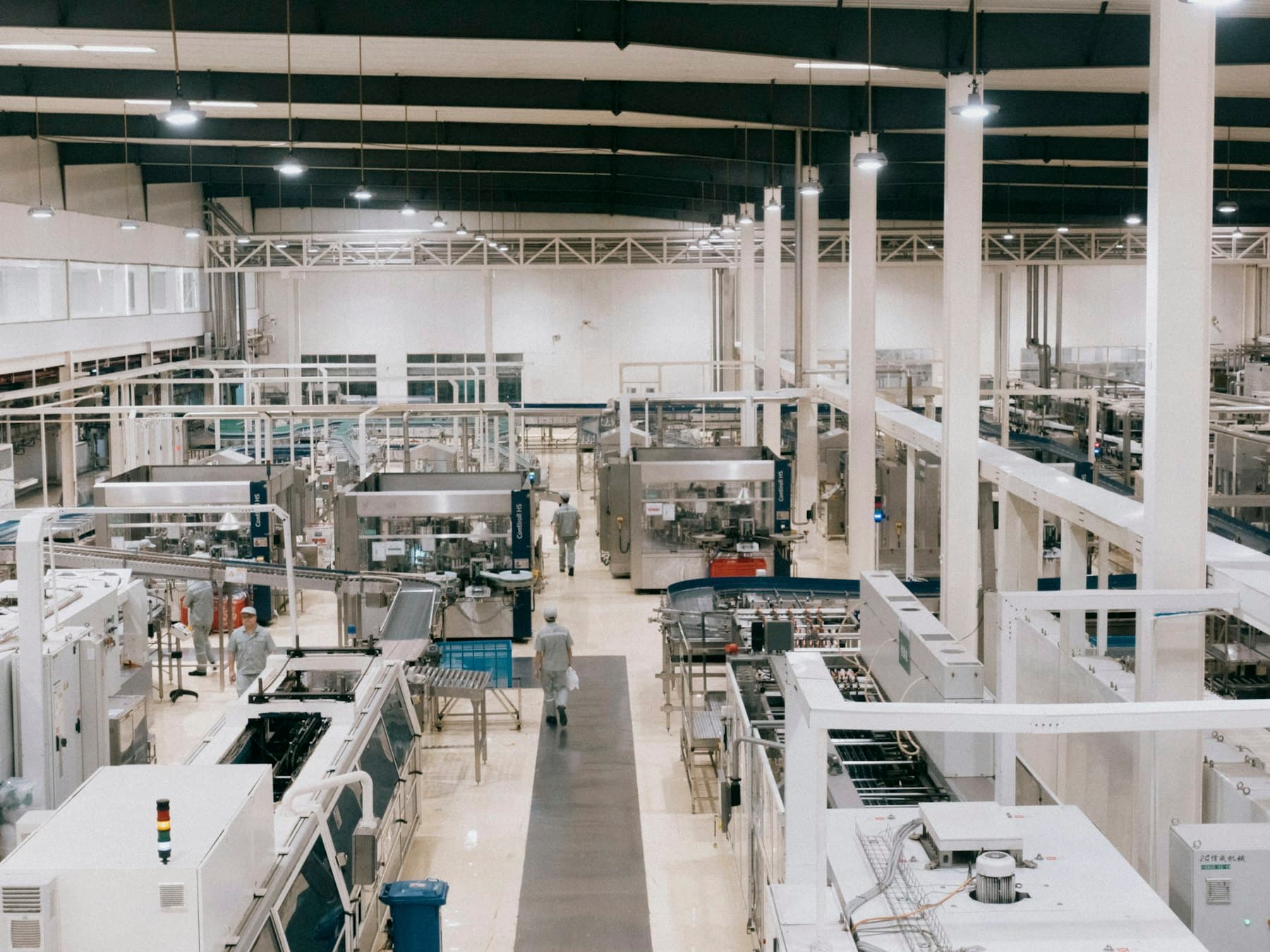 Industrial factory floor with machinery and overhead lighting