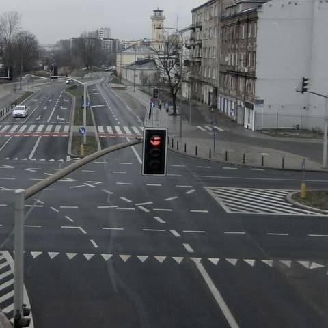 Signalised city intersection with a traffic signal head hung over the carriageway